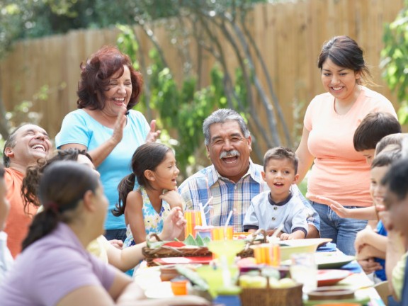 Family eating outside and laughing